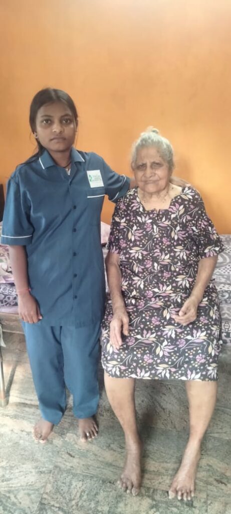 WeCare caregiver helping a senior walk indoors at home in Mangaluru (Nursing Gallery)