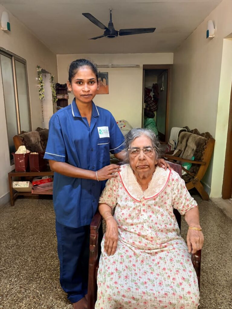 WeCare nurse recording vital signs on a patient chart at home in Karnataka (Nursing Gallery)